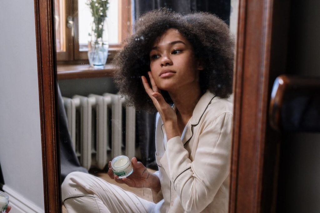 Woman applying moisturiser in the morning as part of a simple skincare routine for beginners