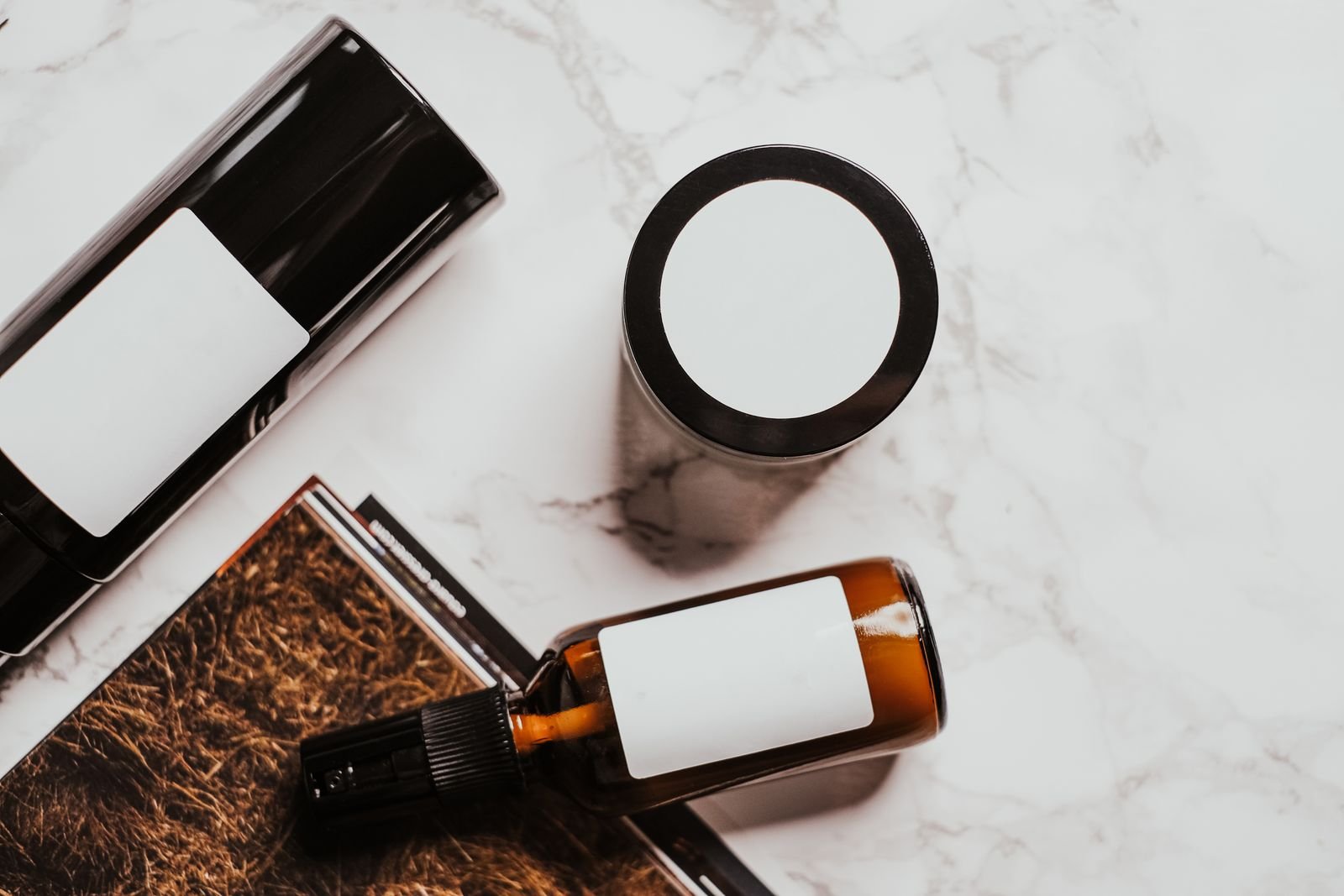Skincare products arranged on marble, for learning how to read skincare ingredient labels