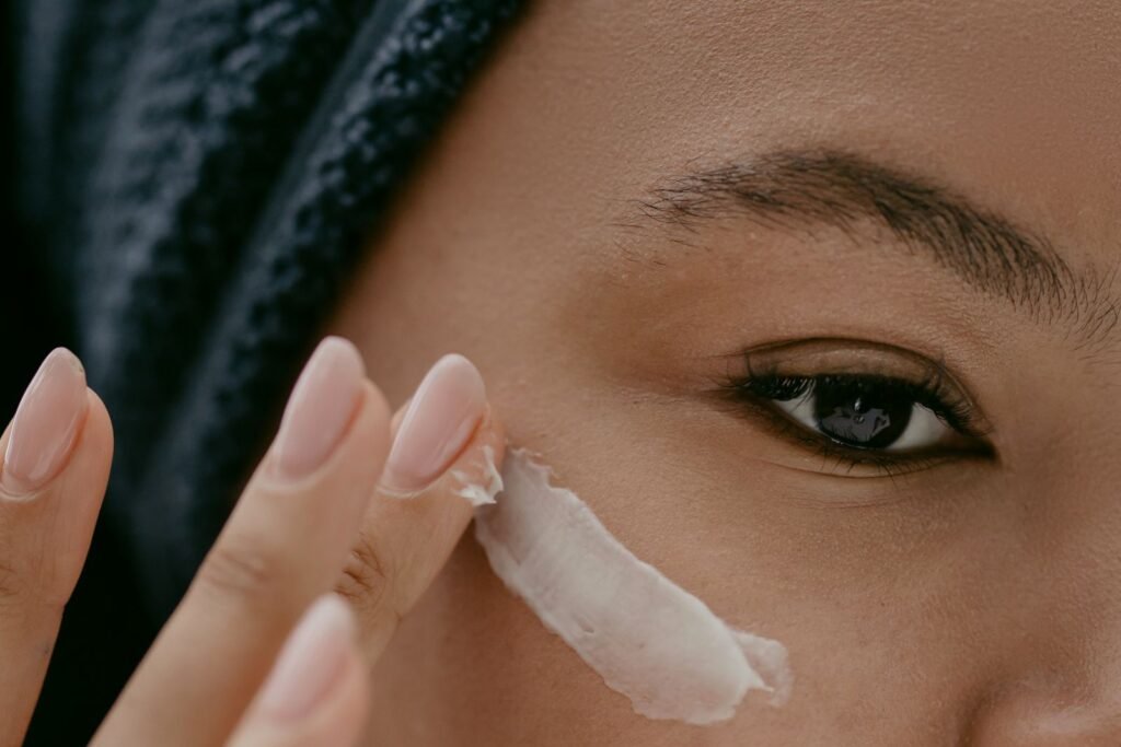 Woman smoothing a rich ceramide cream over her cheek